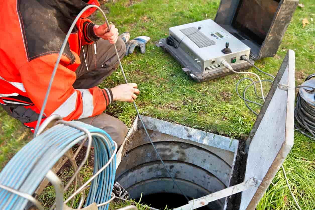 A worker using cctv inside a drain